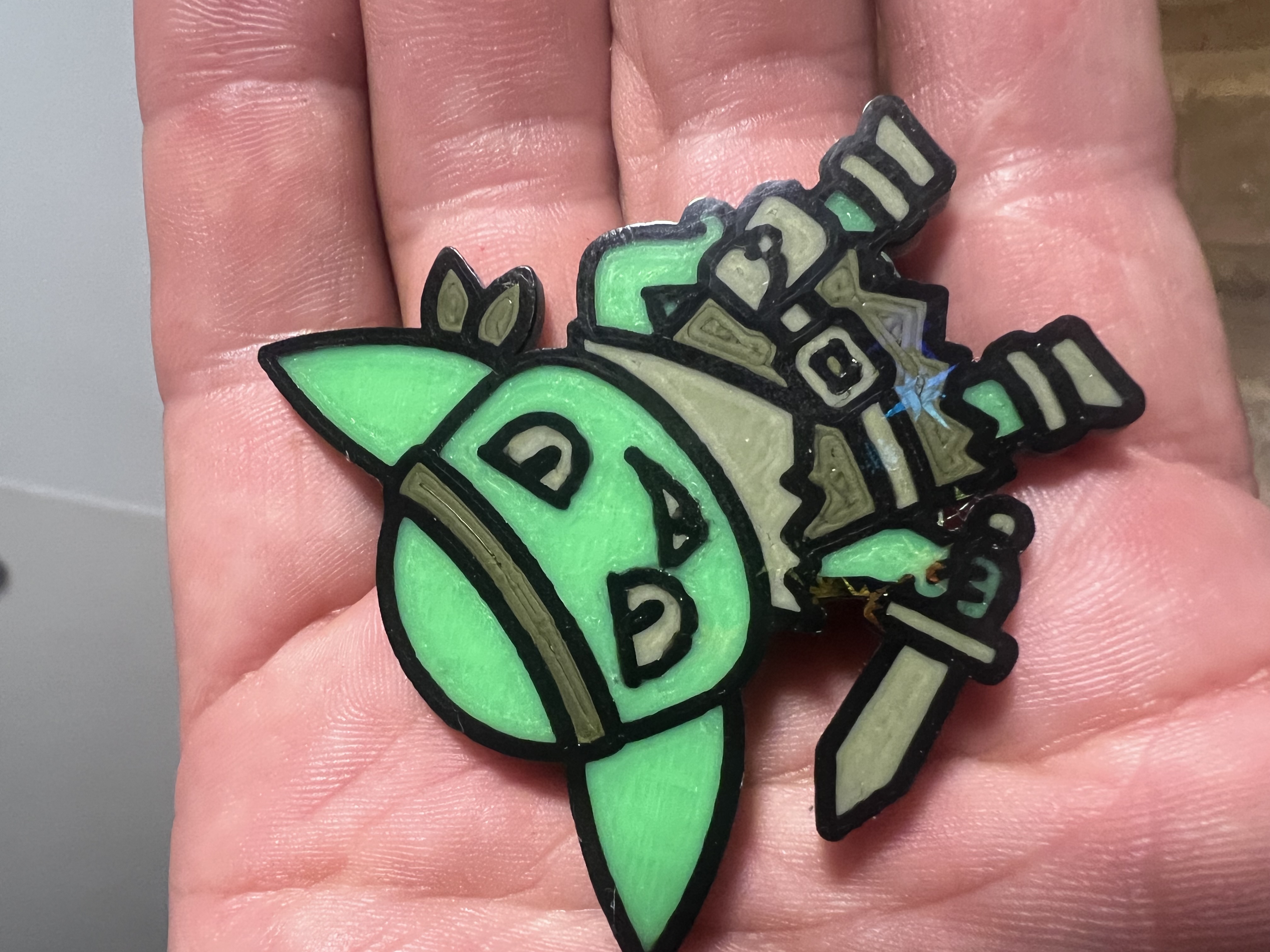 Close-up of the finished multi-color character print held in a hand
